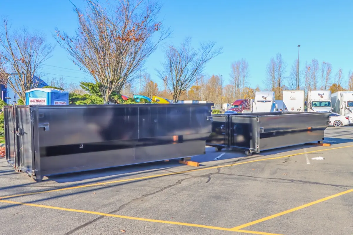 Professional dumpster rental service with roll-off container on residential driveway in Little Canada